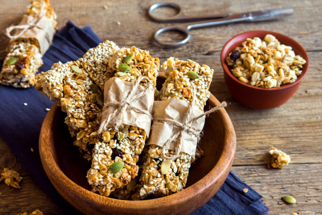 Healthy vegetarian snack - organic homemade granola bars on rustic wooden background